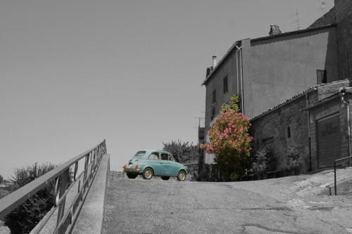 Old car in an old town by Christopher Ottesen